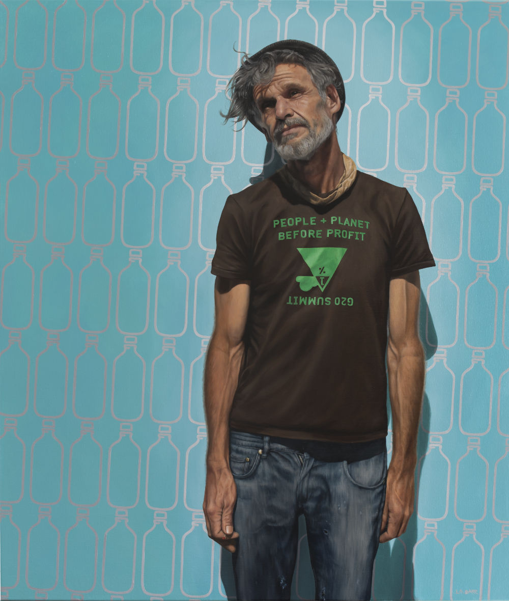 Portrait of man in front of wall of bottles